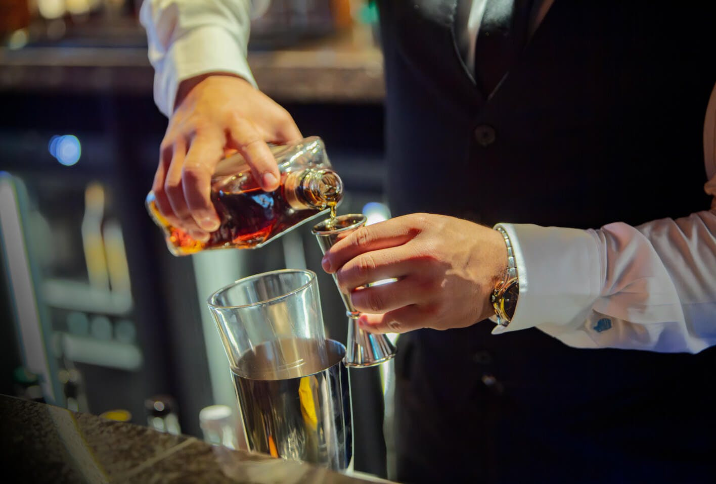 Bar tender pouring a cocktail